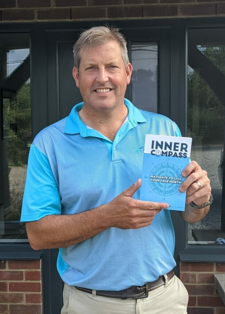 Matt Guiver holding his book "Inner Compass"
